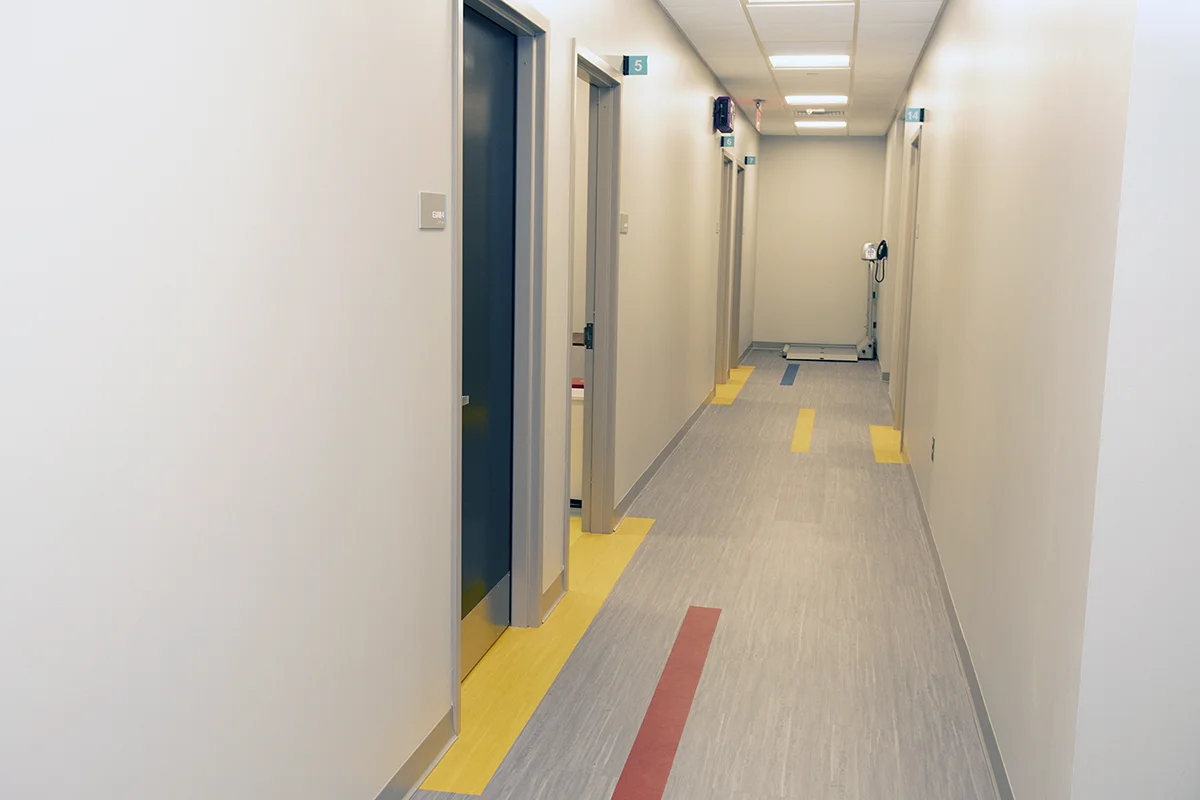 Clean hallway of a doctor's office area with color accents on the floor